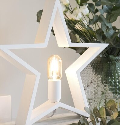 Foto av elegant stjärnformad lampa med varm glöd