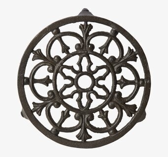 Bild av dekorativt gjutjärns grytunderlägg i mörk nyans