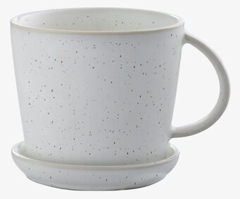 Bild av stilfull tekopp och fat med prickigt mönster