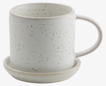 Bild av stilren kaffekopp med prickar i vit färg