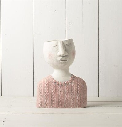 Bild av stilren kruka med ansikte i gammelrosa nyans