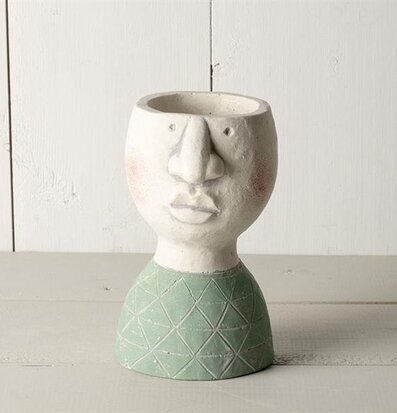 Bild av unik kruka med ansiktsdesign och modern stil