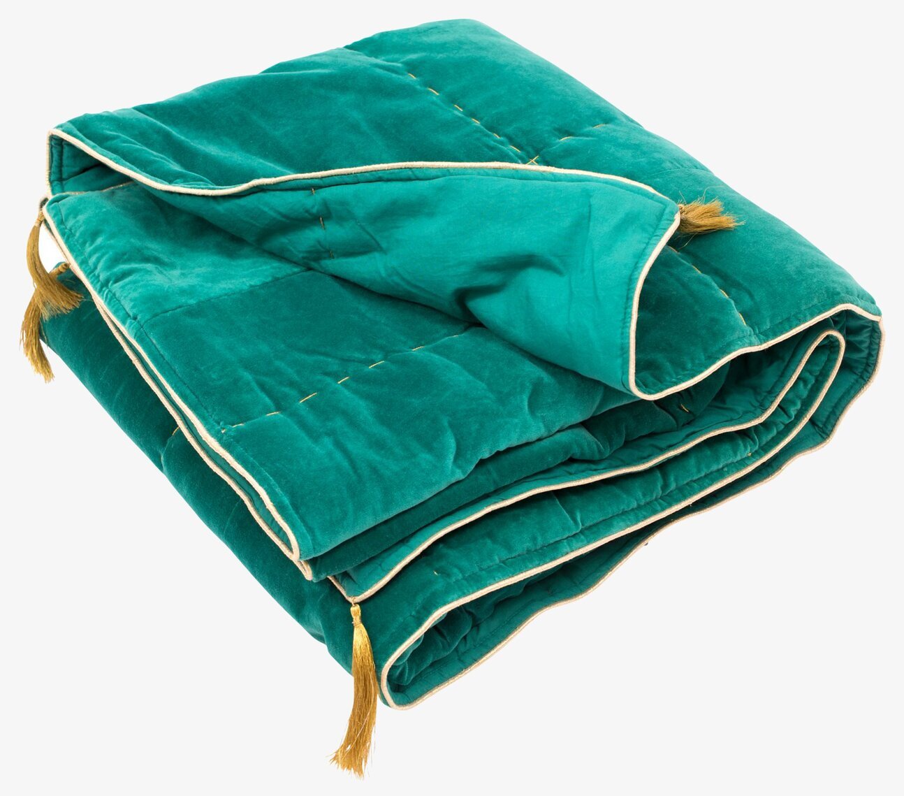Bild av inbjudande filt i jadegrön sammet med tofsar