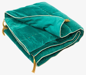 Bild av inbjudande filt i jadegrön sammet med tofsar