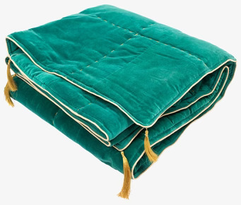 Bild av en lyxig grön sammetsfilt med gulddetaljer