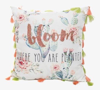 Bild på kudde med botaniskt motiv och glittrande text