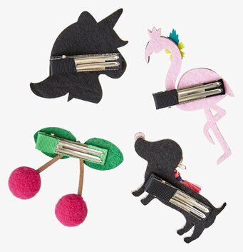 Bild av fyra fantasifulla och färgglada hårspännen