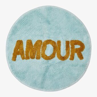 Bild av rund tuftad matta i ljusblå och gyllene färger