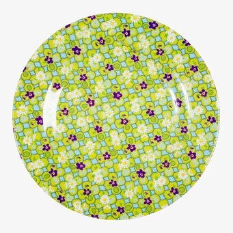 Bild av färgglad tallrik med blommönster och grön bakgrund