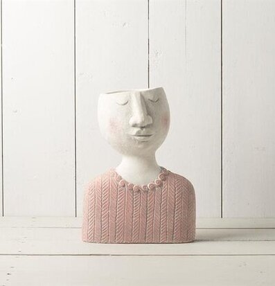 Foto av unik blomkruka med ansiktsdesign i rosa