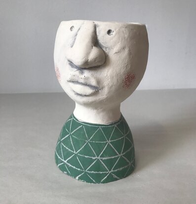 Bild av unik ansiktsformad blomkruka i grön design