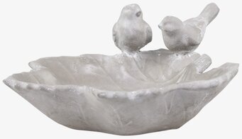 Foto av detaljrik skulptur med fågelbad i lövform