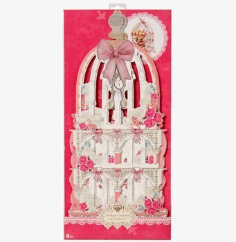 Bild av rosa kakfat i form av dekorativ fågelbur