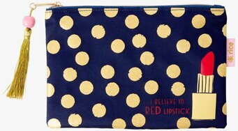 Bild av stilren necessär med guldprickar och läppstift