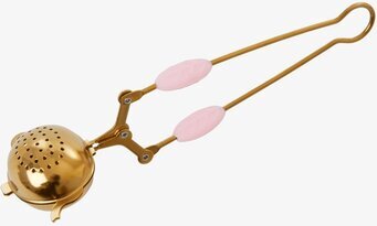 Bild av elegant tesil med gyllene och rosa detaljer