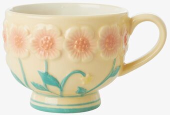 Bild av keramikmugg med blommig design och handtag