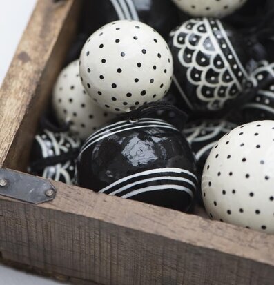 Foto av dekorativa kulor i rustik trälåda med beslag