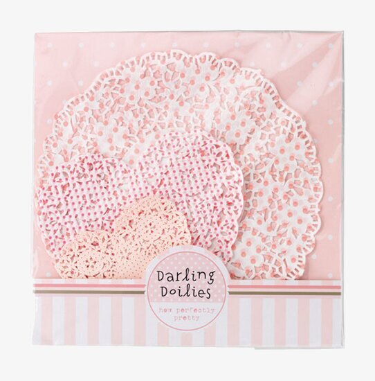 Bild av dekorativa tårtpapper i rosa och vitt