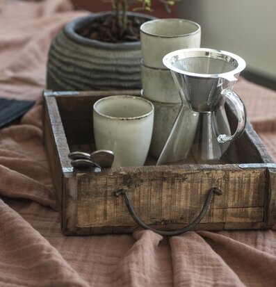 Bild av rustik trälåda med keramikkoppar och glaskanna