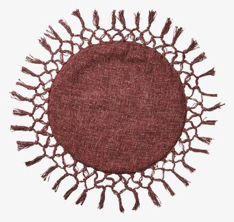 Bild av rund kudde i roströd nyans med franskant