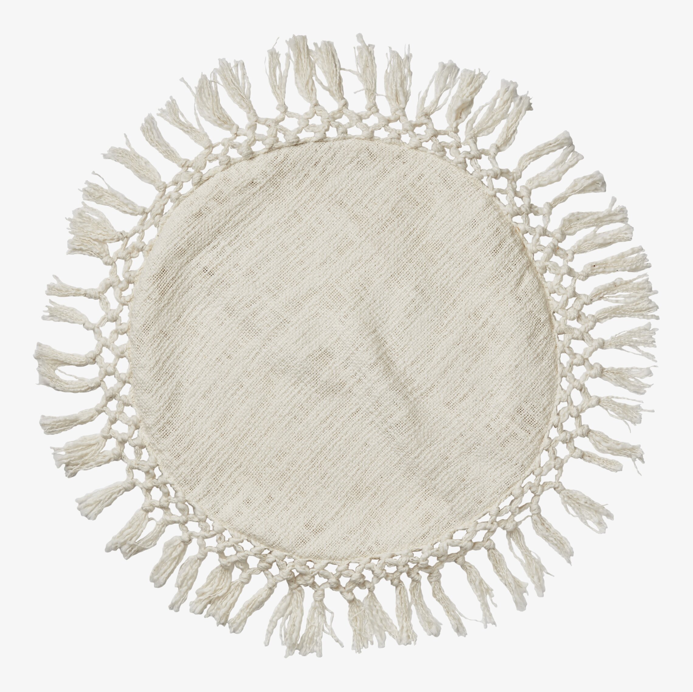 Bild av rund kudde med elfenbensfärg och fransar
