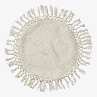 Bild av rund kudde med elfenbensfärg och fransar