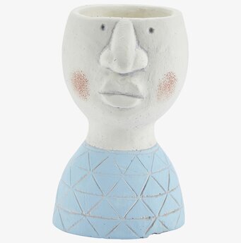 Foto av unik blomkruka med ansiktsdesign i blått