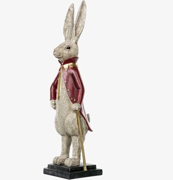 Bild av elegant kaninskulptur i röd rock med guldknappar