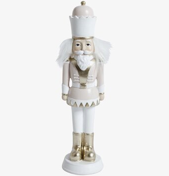 Bild av rosa nötsknäppare med guld- och vitdetaljer