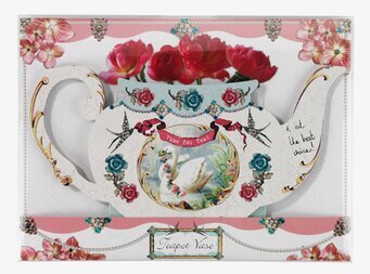 Bild av dekorativ vas i form av en tekanna med rosor