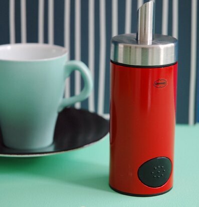 Bild av livfull köksscen med stilren röd ströare