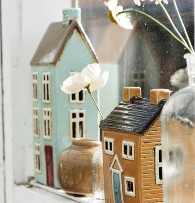 Bild av hemtrevlig scen med ljuslyktor och blommor