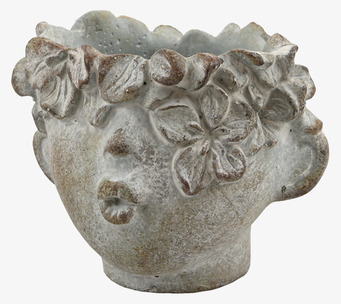 Bild av unik kruka med ansiktsdesign och blommönster