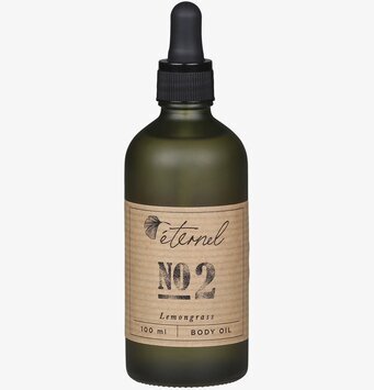 Bild av elegant flaska i grönt glas med svart pipett