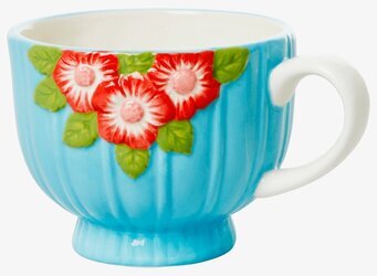 Bild av keramikmugg med mintgrön och blommig design