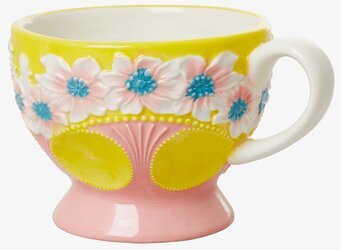 Bild av färgglad keramikmugg med blommönster