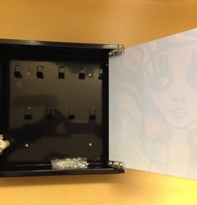 Bild: Stilrent svart nyckelskåp med konstnärlig insida