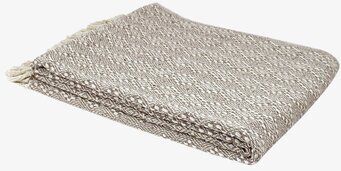 Bild av stilren beige pläd med tofsar och mönster