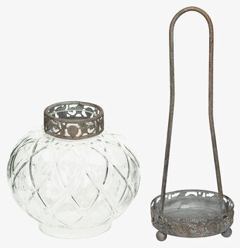 Bild av glaslykta med dekorativ metallkant och hållare