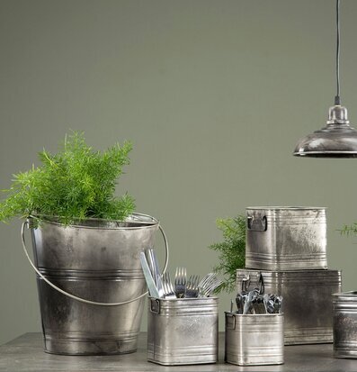 Bild av industriella metallbehållare med grön växt