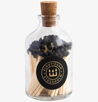 Bild av stilren glasburk med tändstickor och korklock