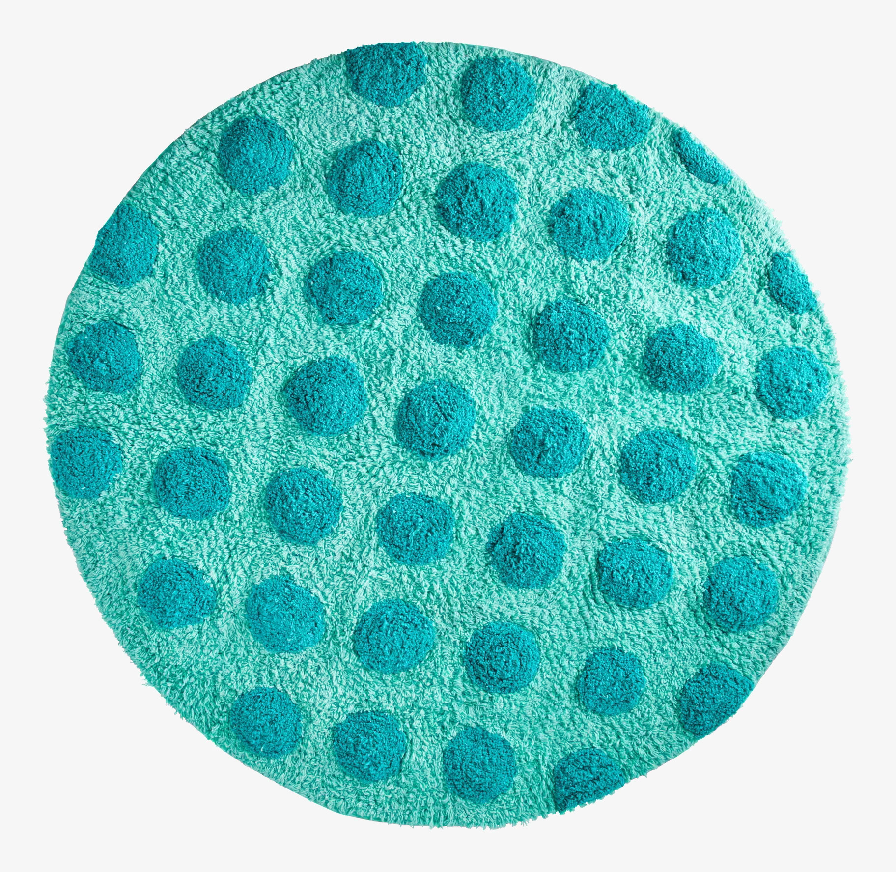 Bild av rund tuftad matta med gröna prickar