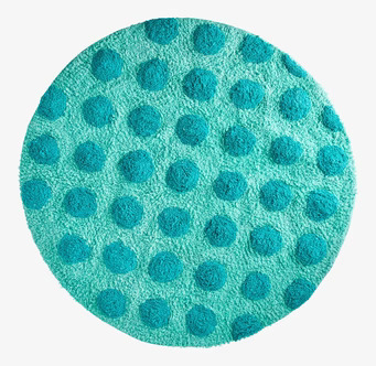 Bild av rund tuftad matta med gröna prickar