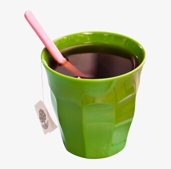 Bild av en grön mugg med rosa sked och tésnöre