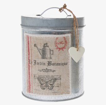 Bild av en stor, dekorativ metallburk med botaniskt tema