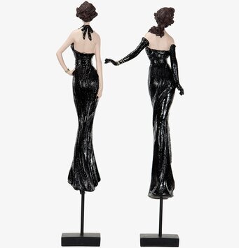 Bild av eleganta dekorativa figurer i svart klänning