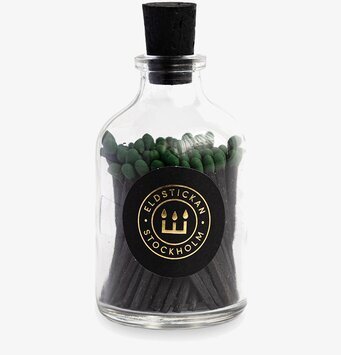 Bild av stilren glasflaska med tändstickor