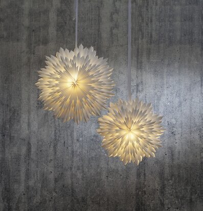Bild av dekorativ ljussättning med pappersstjärnor