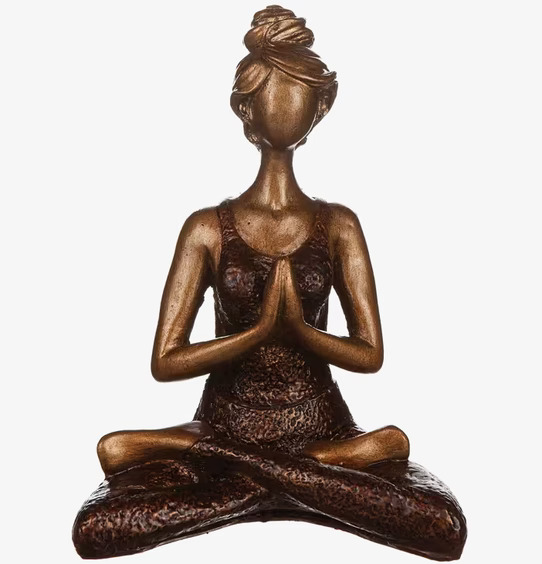 Bild av statyett i brun och gyllene yogaposition
