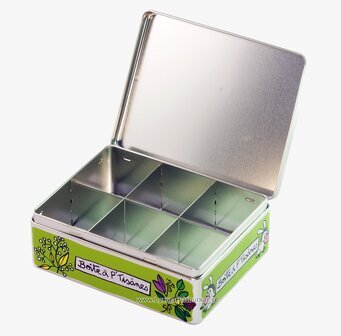 Foto av grön plåtburk med åsnor och växtmotiv